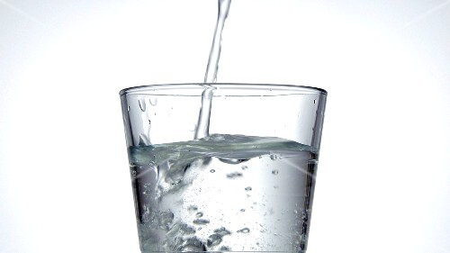 Pouring a glass of mineral water