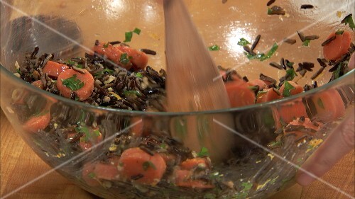 Making wild rice, carrot and pecan salad
