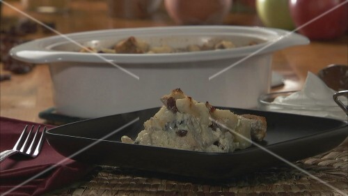 Making bread and butter pudding with apples and raisins