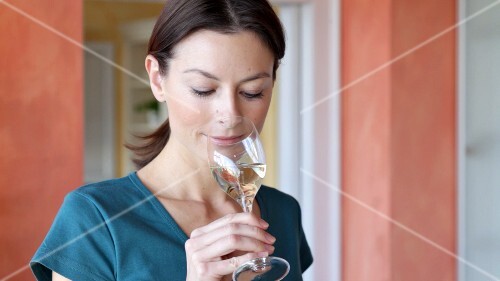 Woman drinking a glass of white wine
