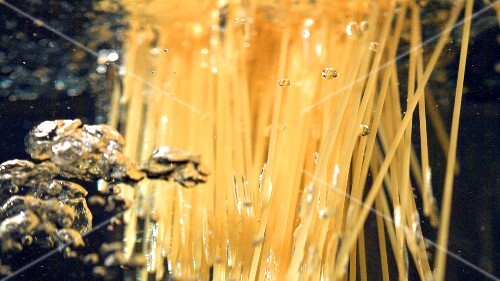 Putting spaghetti into boiling water