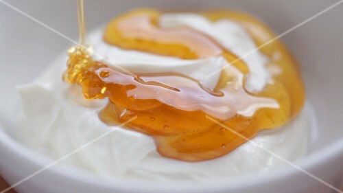 Honey running onto yoghurt