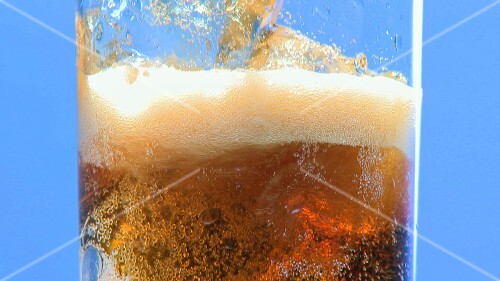 Pouring cola into a glass