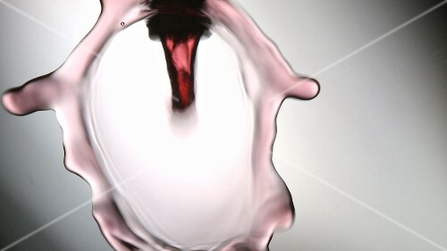 Pouring red wine into a glass