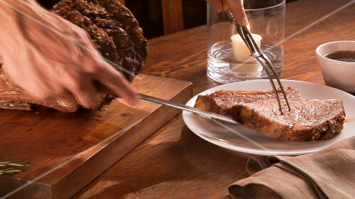 Plating roast prime rib steak and serving with gravy
