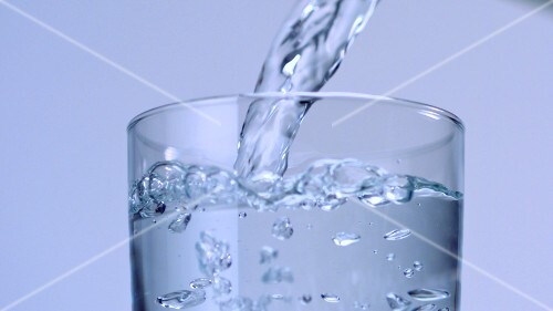 Pouring water into a glass
