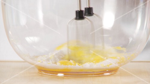 Beating together egg yolks and sugar
