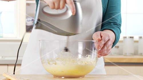 Mascarpone being mixed with the egg yolk-sugar mixture