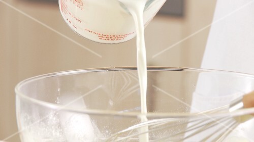 Milk being added and stirred into a dough