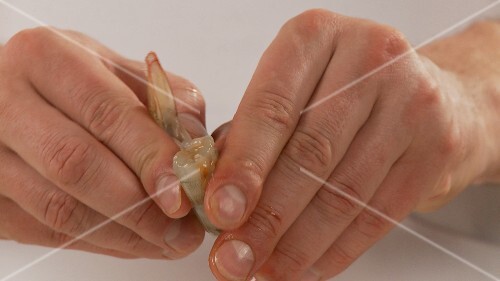 Cleaning prawns: removing the head and shell