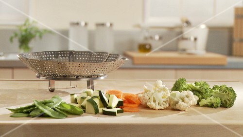 Prepared vegetables and a steamer