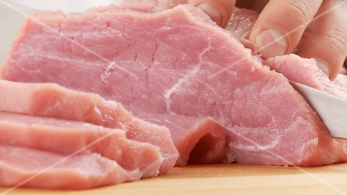 Escalopes being cut from the top side of veal