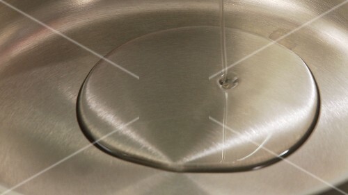 Vegetable oil being poured into a pot