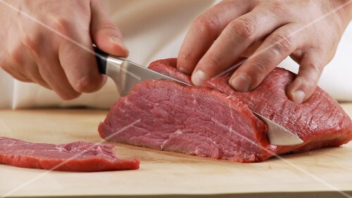 Veal shoulder being sliced