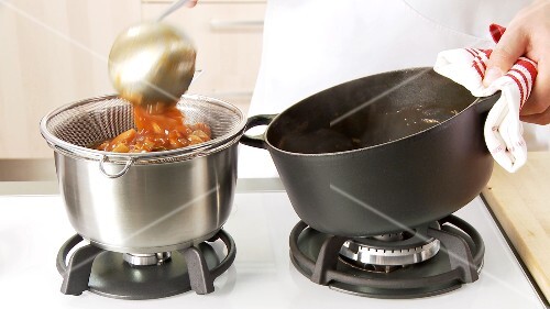 Meat juices and vegetables being sieved