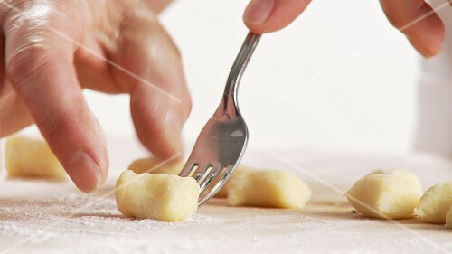 Gnocci being rolled over a fork