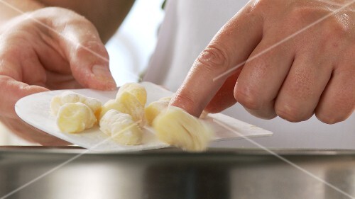 Gnocchi being added to salt water