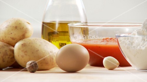 Ingredients for gnocci with tomato sauce: potatoes, egg, flour, tomato sauce, olive oil