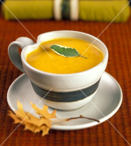 A Cup of Pumpkin Soup with a Sage Leaf