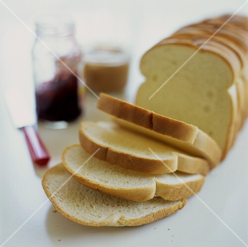 White bread, sliced; jam; peanut butter