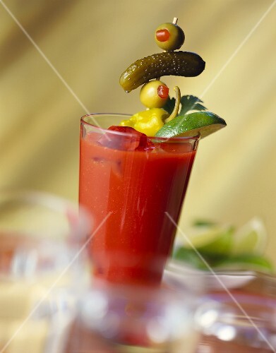 Bloody Mary with olive on cocktail stick and lime wedge