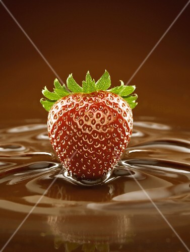 A Fresh Strawberry in a Pool of Chocolate