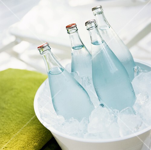 Four bottles of water in an ice bucket