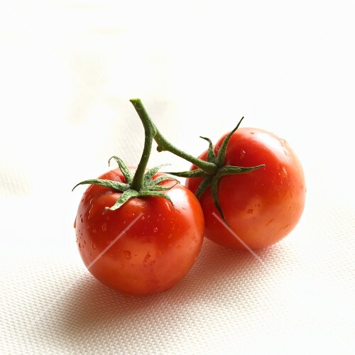 Two Red Tomatoes Connected at the Stem