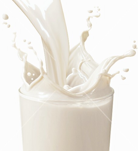 Vanilla Milk Pouring into a Glass; Splashing