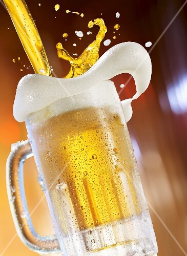 Beer being poured into a glass tankard
