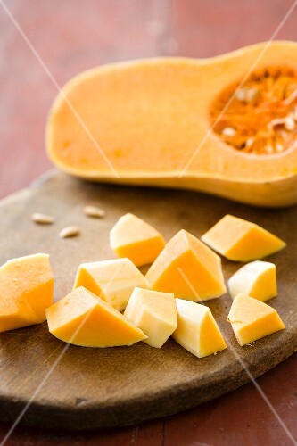 Butternut Squash Peeled and Cut on Cutting Board; Half of Squash