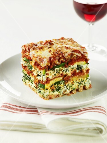 A slice of spinach and courgette lasagne on a plate