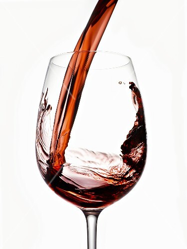 Red Wine Pouring into a Glass From Bottle