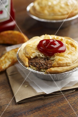 Australian Meat Pie with Pie of Top Pastry Removed; Served with Ketchup; Oven Fries
