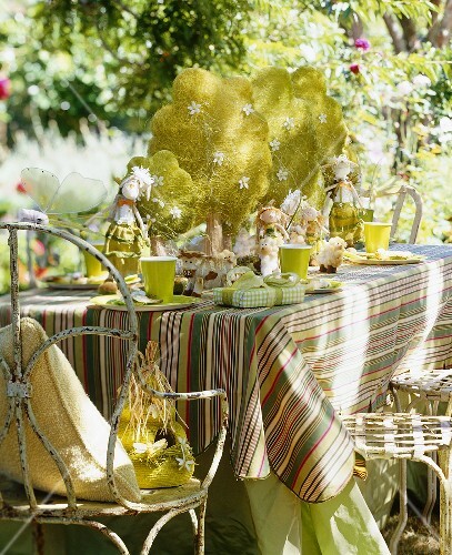 A table decorated for a children's summer party with toy animals and figures