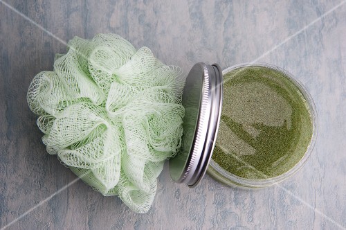 Bath oil and a bath sponge (close-up)