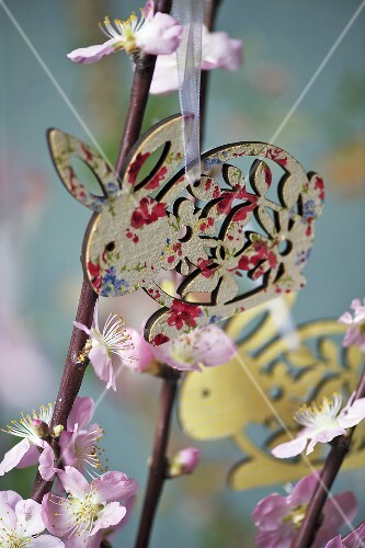 A wooden rabbit decoration hanging from flowering twigs