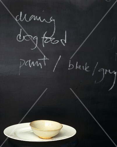 A blackboard in the kitchen serves as an aide-memoire to buy dog food and other vital things