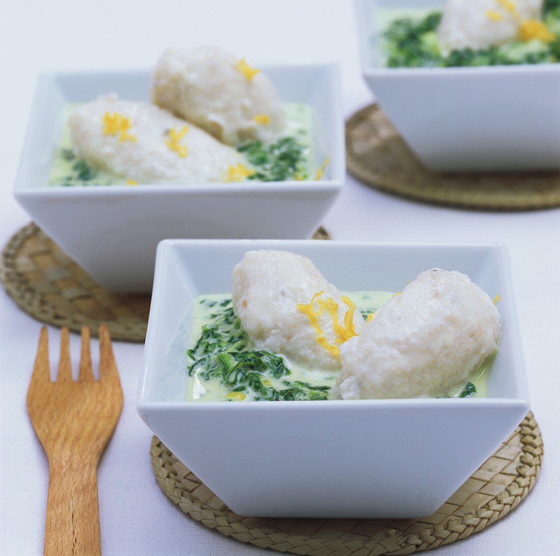 Fish dumplings in spinach cream sauce