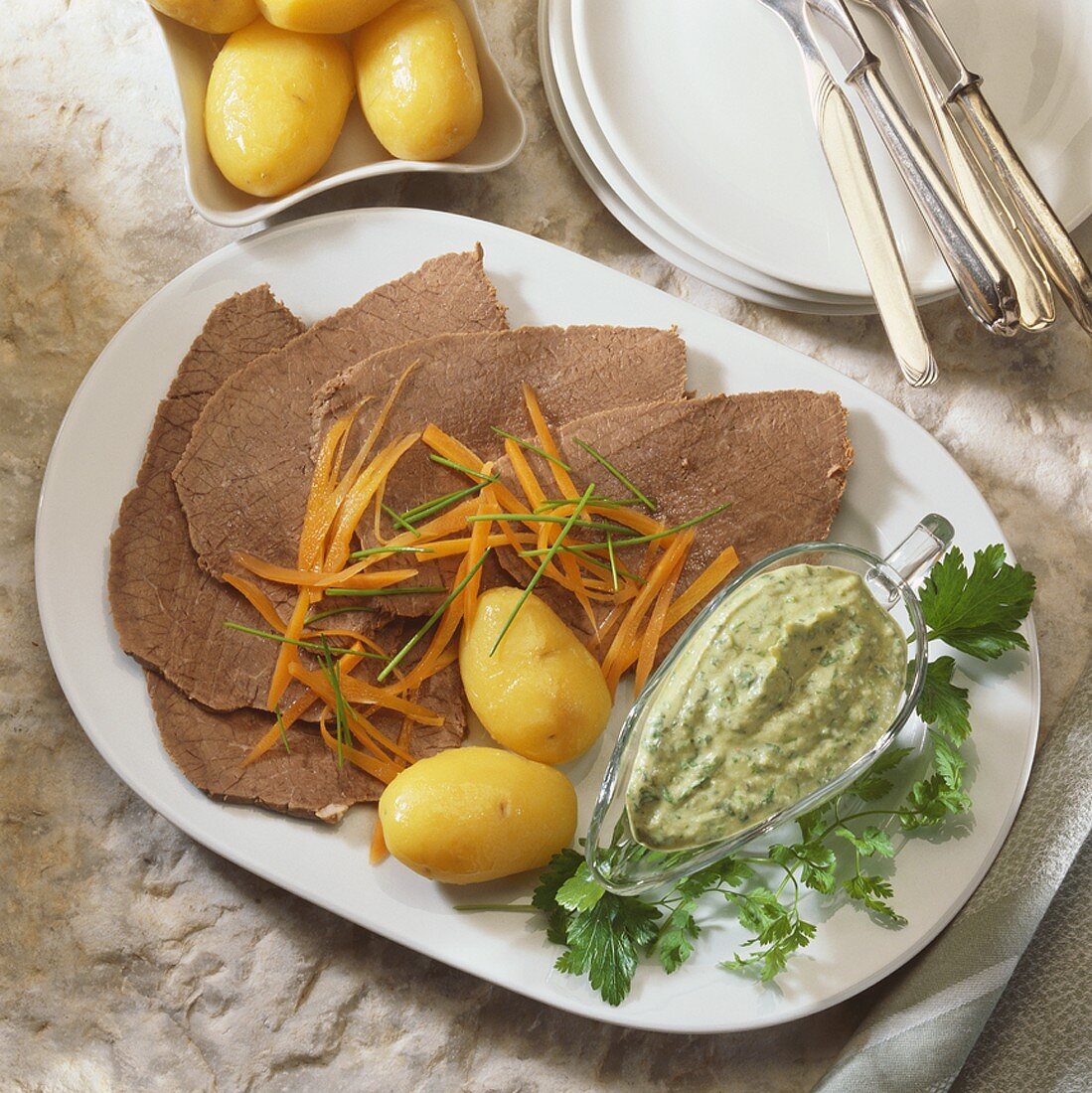 Boiled beef with carrots, potatoes and parsley & chervil sauce
