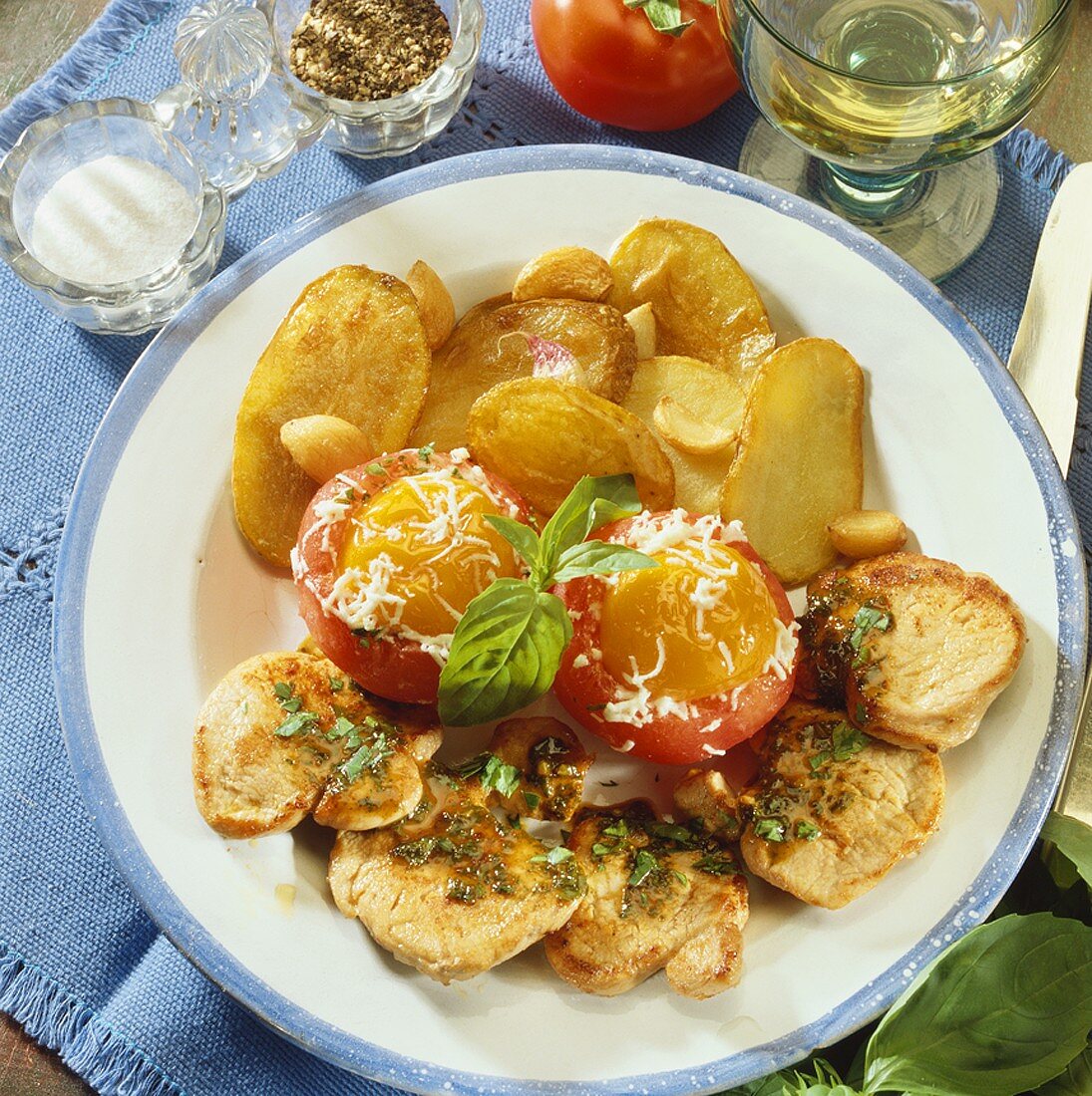 Pork fillet with fried potatoes, tomatoes and eggs