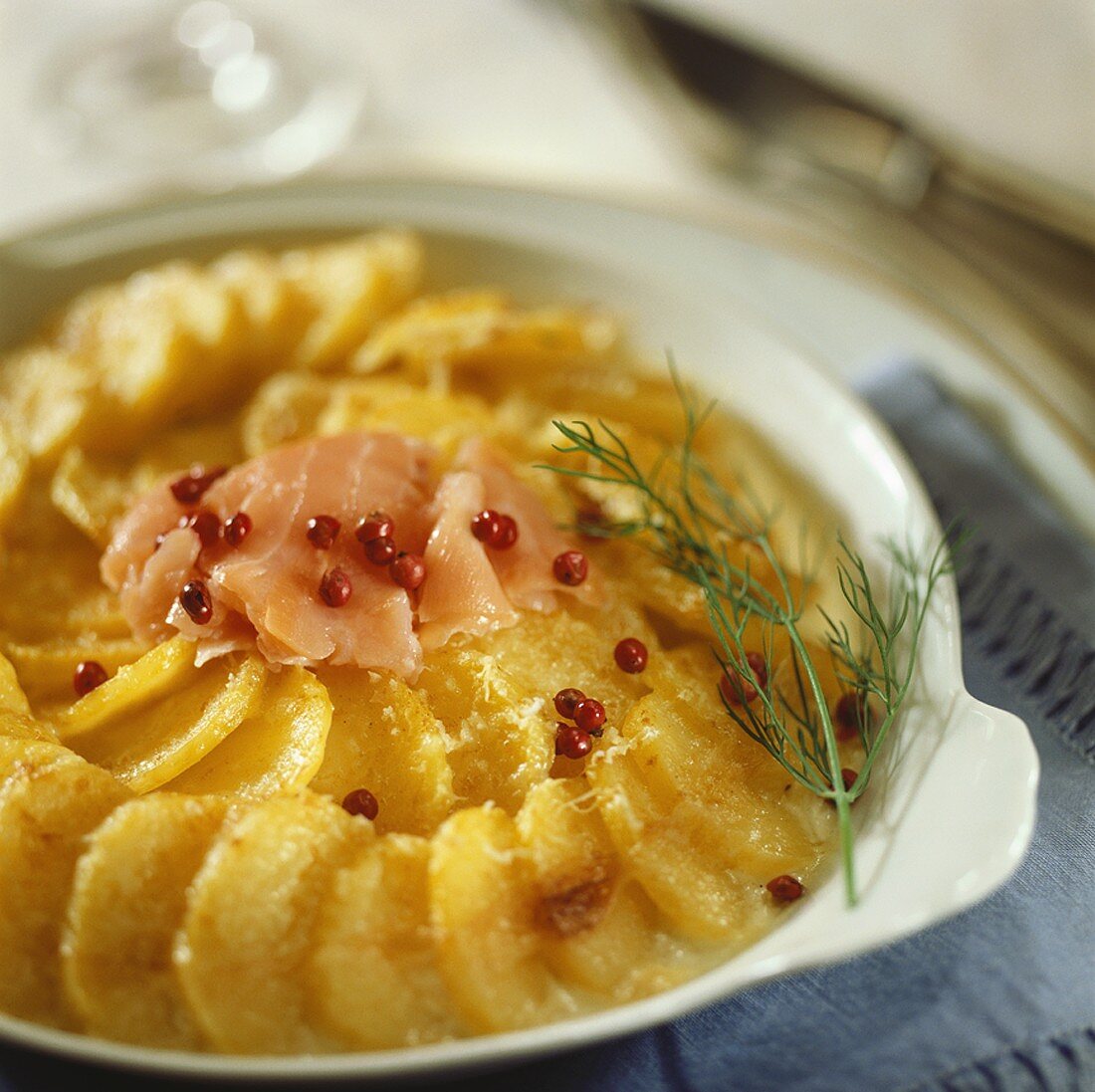 Potato gratin with smoked salmon and red peppercorns