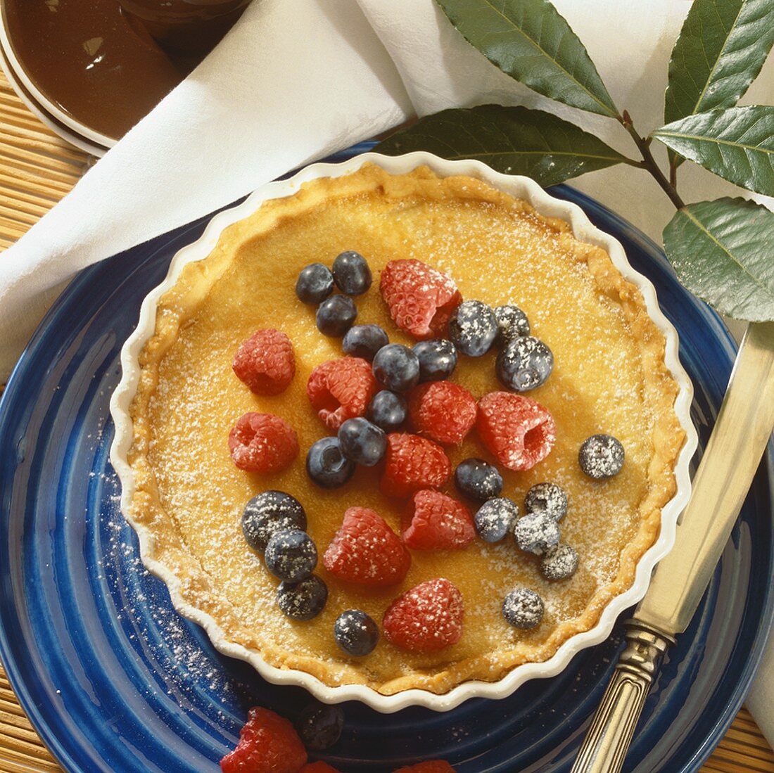 Lemon sour cream tart garnished with summer berries