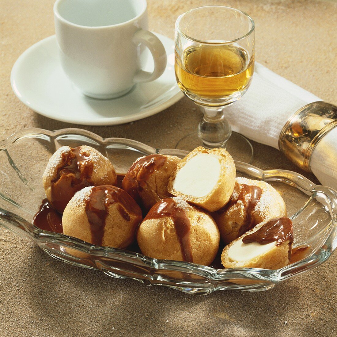 Cream-filled profiteroles with chocolate sauce