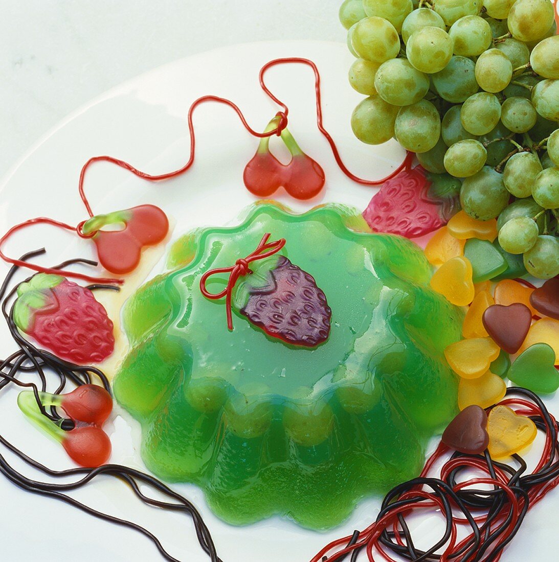 Green jelly decorated with sweets