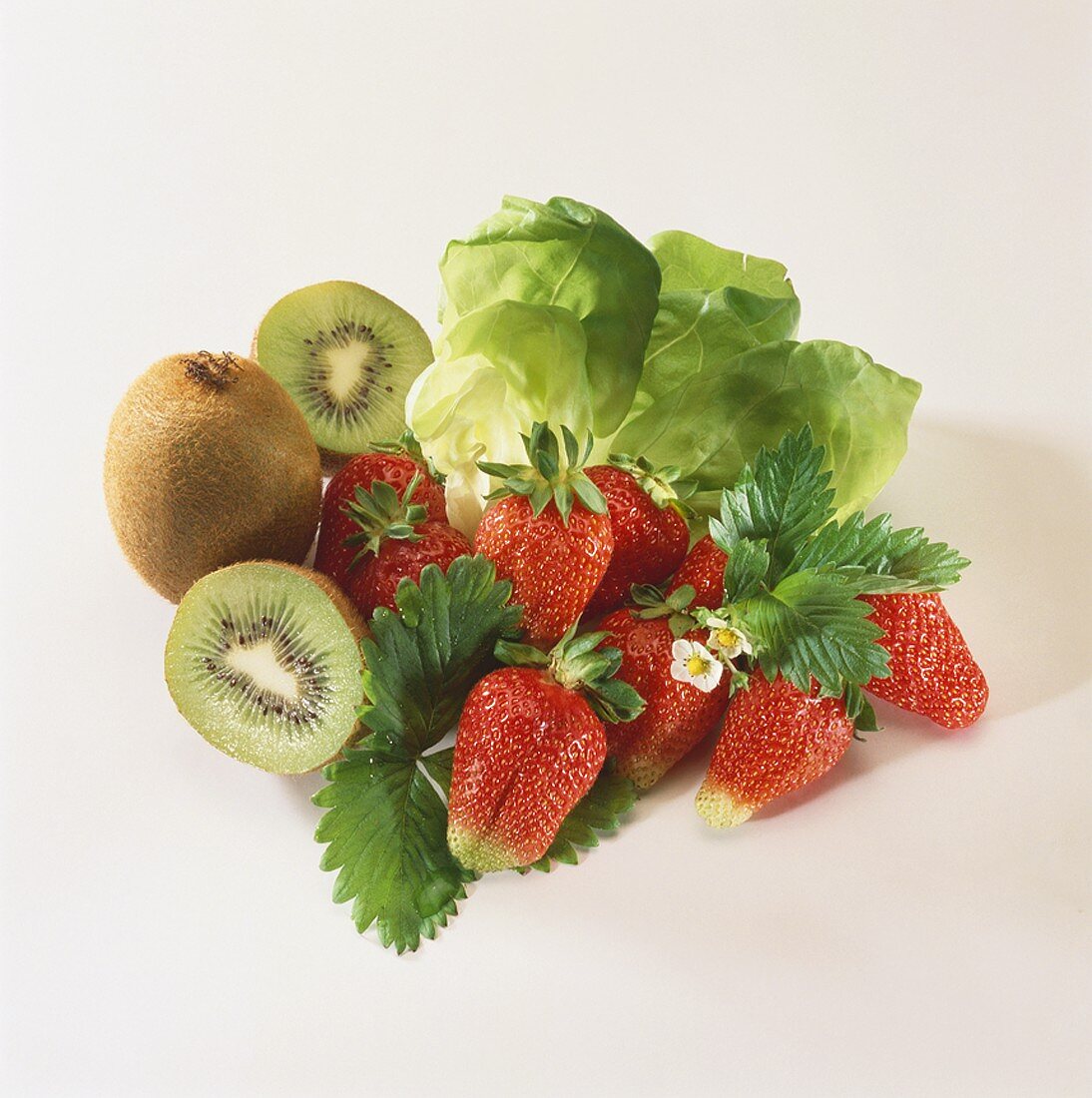 Fresh strawberries, kiwi fruits and lettuce leaves