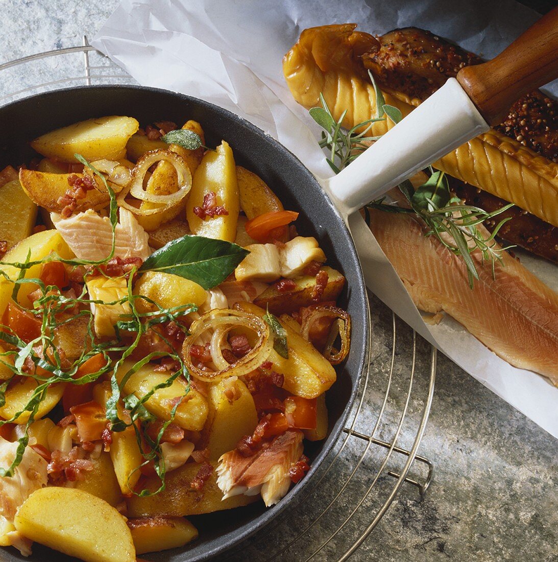 Pan-cooked fish, potatoes, tomatoes and bacon