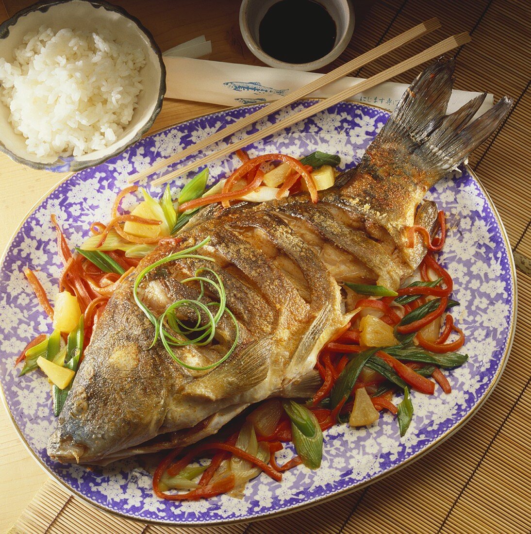 Fried carp with Asian vegetables, soy sauce and rice