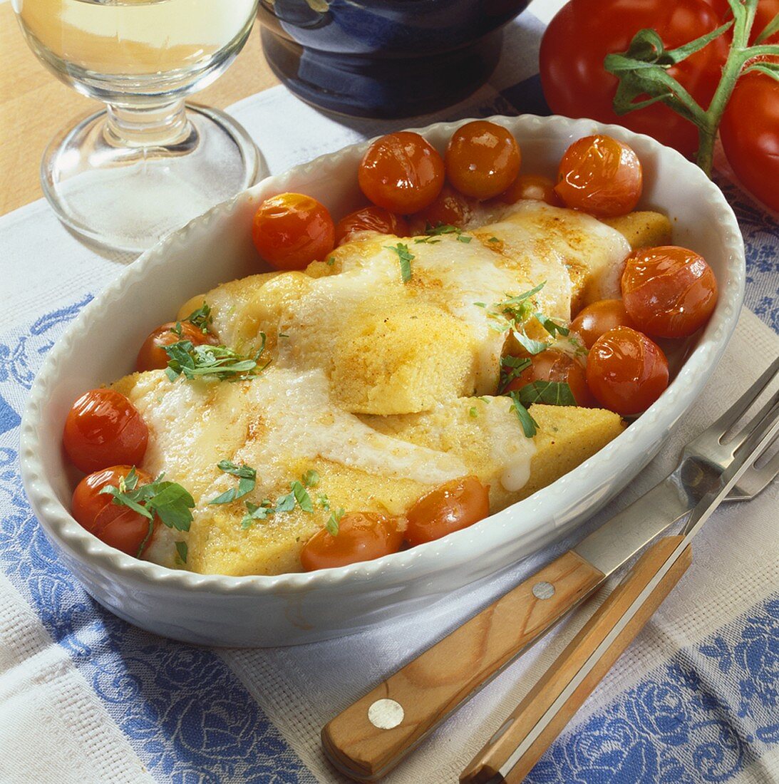 Baked polenta slices with cherry tomatoes and cheese