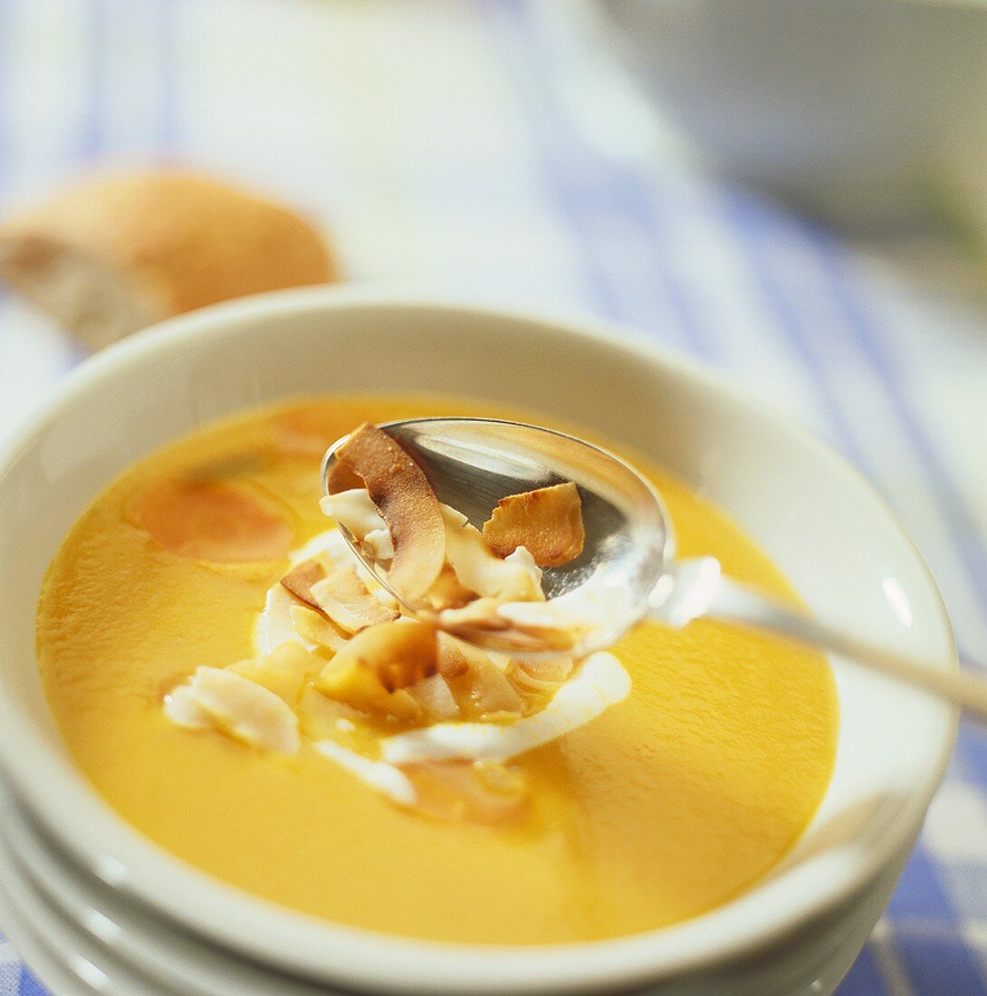 Carrot soup with coconut milk and coconut shavings